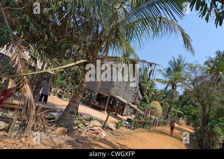 Horizontal wide angle view of a house on stilts in a typical rural scene in Cambodia. Stock Photo