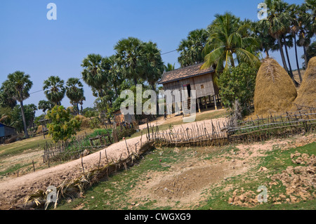 Horizontal wide angle view of a typical wooden house on stilts in rural Cambodia Stock Photo