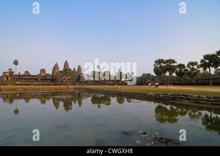 Horizontal view of the amazing architecture at Prasat Angkor Wat reflected in the water at sunrise. Stock Photo
