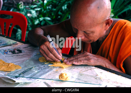 Monk carving with wax on 1/08/2012 at the Candle and wax festival (Khao Phansa) in Ubon ratchathani Northeastern Thailand Stock Photo