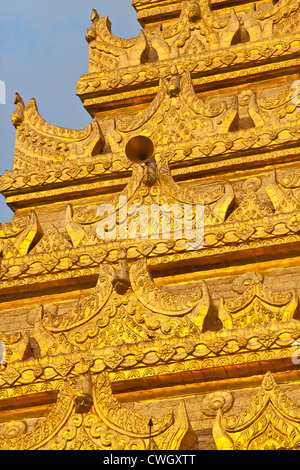 The gilded many tiered pagoda of the MAHAMUNI PAYA or TEMPLE built by King Bodawpaya in 1784 - MANDALAY, MYANMAR Stock Photo