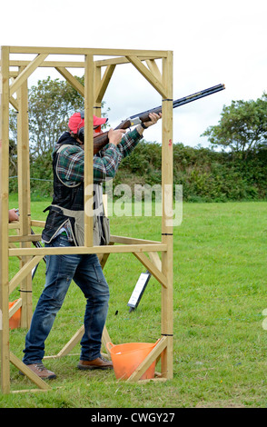 A male competitor in a Clay Pigeon shooting competition at a country fair near Camborne in Cornwall, UK Stock Photo