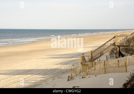 wooden beach access stairway over sand dune almost deserted beach Corolla, North Carolina Outer Banks Stock Photo