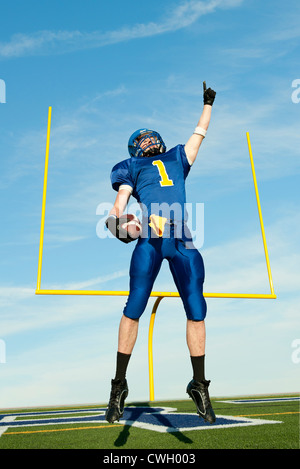 Caucasian football player cheering for victory Stock Photo