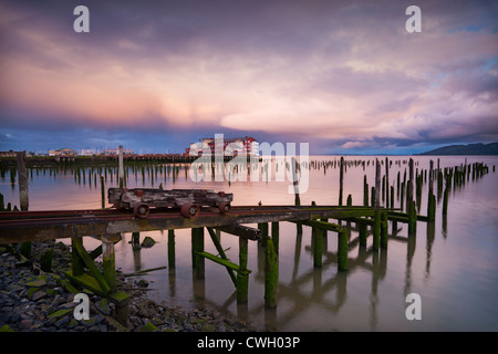 Spectacular clouds and sunrise light reflected in the Columbia River with hundred-year old pilings and the Cannery Pier Hotel, Astoria, Oregon, USA Stock Photo