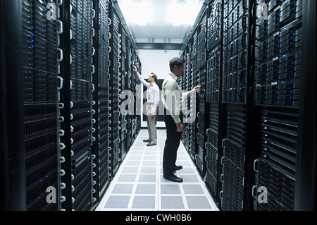 Businessmen working in server room Stock Photo