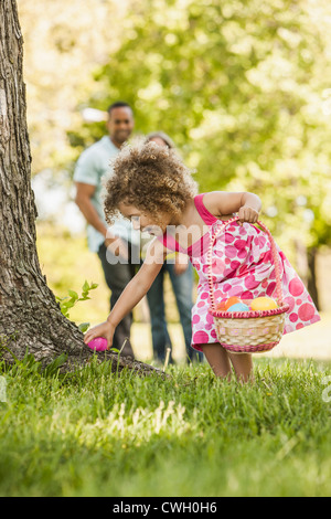 Mixed race girl on Easter egg hunt Stock Photo