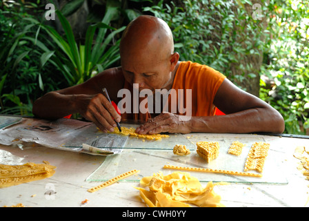 Monk carving with wax at the candle and wax festival (Khao Phansa) on 3/08/2012 in Ubon Ratchathani Northern Thailand Stock Photo