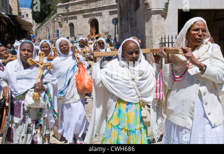 Ethiopian Christian pilgrims carry across along the Via Dolorosa in Jerusalem , Israel Stock Photo