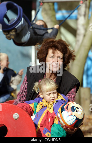Berlin, a grandmother playing with a girl on a playground ball Stock Photo
