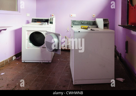 Washing machine and tumble drier in the laundry room of an abandoned B&B house hotel Stock Photo