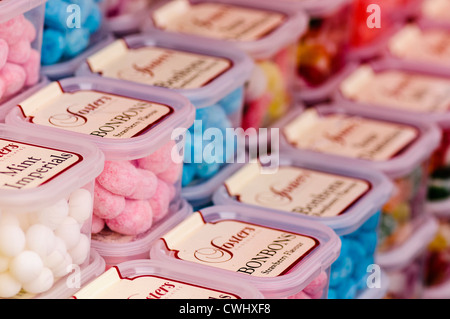 Tubs of Foster's sweets, including bonbons and mint imperials, on sale at a market stall Stock Photo