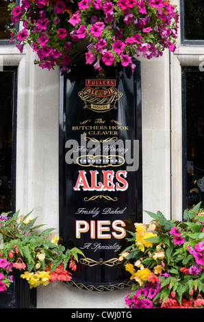 A sign advertising ales and pies outside a pub, Smithfield, London, England Stock Photo