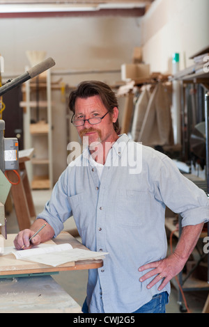 Caucasian carpenter in workshop Stock Photo