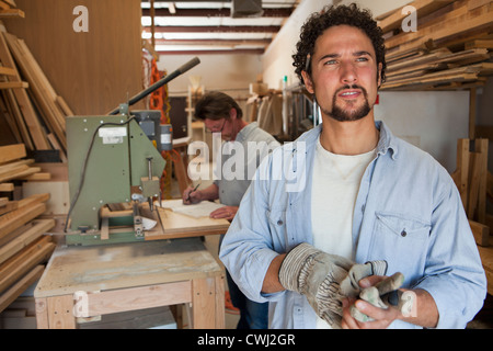 Co-workers woodworking in workshop Stock Photo