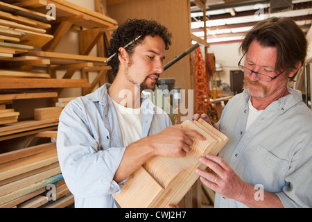 Co-workers woodworking in workshop Stock Photo