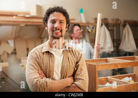 Co-workers woodworking in workshop Stock Photo