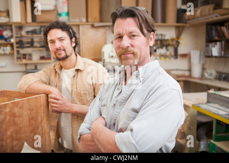 Co-workers woodworking in workshop Stock Photo