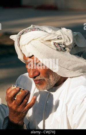 Elk207-1492v Oman, Muscat, Muscat Festival, Bedouin encampment, portrait of man drinking coffee Stock Photo