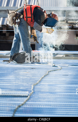 Caucasian construction worker welding floor Stock Photo