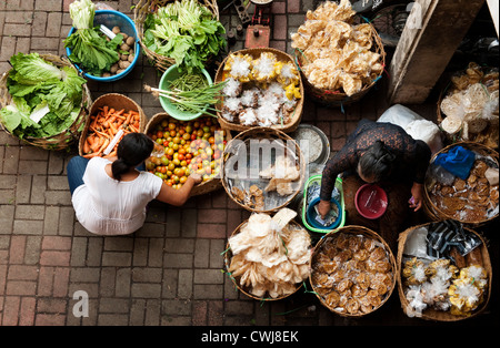 The Ubud, Bali Public Market is a very busy and colorful place with shoppers and sellers arriving very early in the morning. Stock Photo