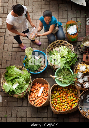 The Ubud, Bali Public Market is a very busy and colorful place with shoppers and sellers arriving very early in the morning. Stock Photo