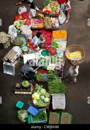 The Ubud, Bali Public Market is a very busy and colorful place with shoppers and sellers arriving very early in the morning. Stock Photo