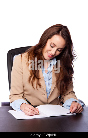 Beautiful attractive happy smiling corporate lawyer business woman sitting at desk and writing blank paper page, isolated. Stock Photo