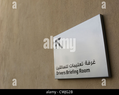 A sign at Yas Circuit Formula 1, Yas Island, Abu Dhabi, pointing the way to the drivers briefing room. Stock Photo