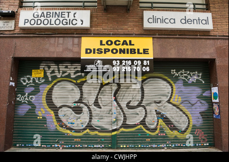 Graffiti on roller security shutter of shop in Barcelona, Catalonia, Spain, ES Stock Photo