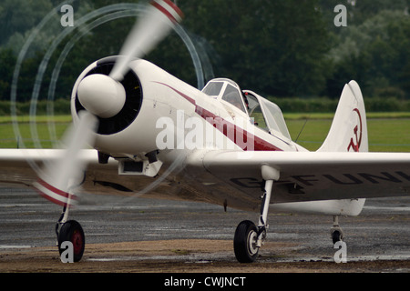 Yak 50 aerobatic aircraft G-FUNK at the Tibenham Heritage Air Festival. Engine running in the rain Stock Photo