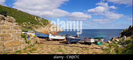 Panoramic photo of Penberth in Cornwall with fishing boats on the cobbled causeway on a bright summers day Stock Photo