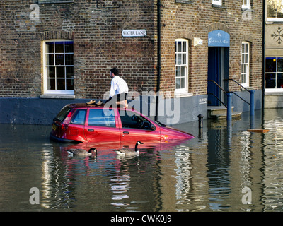 A stranded motorist waits  for help on  the top of his car  as the high tide causes flooding along the River Thames - Richmond Stock Photo