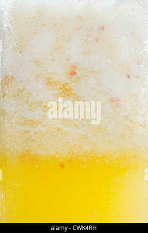Close up of orange, pineapple, apple shake in glass Stock Photo