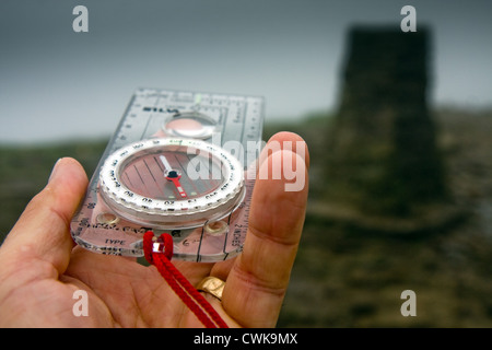 Using a magnetic compass to navigate on Pen-y-ghent in the Yorkshire Dales Stock Photo