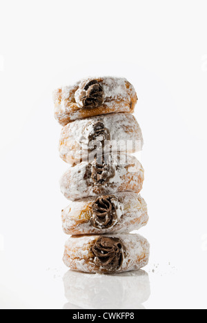 A leaning tower of temptingly delicious strawberry-filled donuts Stock Photo