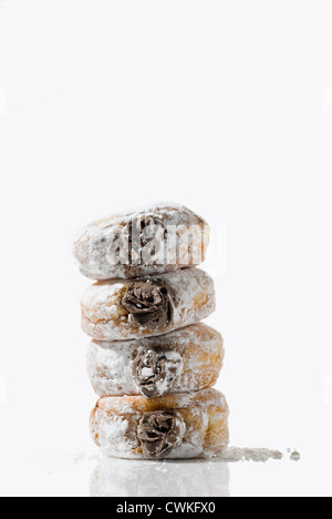 A leaning tower of temptingly delicious strawberry-filled donuts Stock Photo