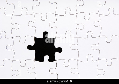 Jigsaw puzzle in white with a missing piece Stock Photo