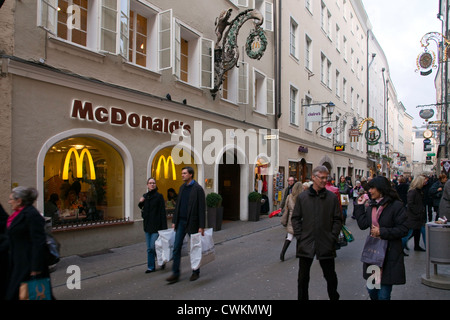 McDonald's metal guild-type Golden Arches sign, fits in among other shops on Salzburg's famed Getreidegasse. Editorial use only. Stock Photo