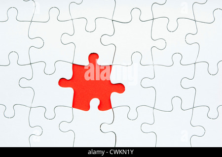 Jigsaw puzzle in white with a missing piece Stock Photo