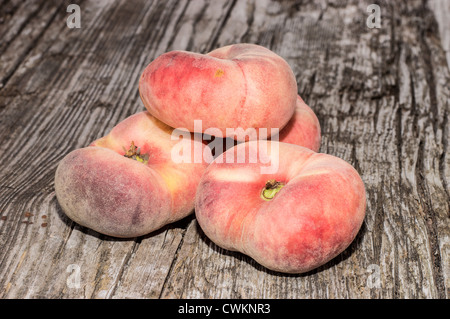 Heap of Wild Peaches on wooden background Stock Photo