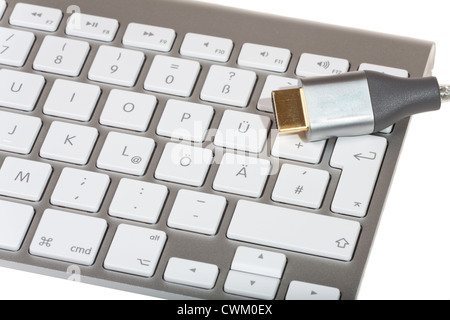 HDMI Cable on computer keyboard isolated on white background Stock Photo