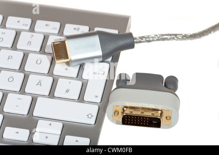 HDMI Cable and HDMI -DVI Converter on computer keyboard isolated on white background Stock Photo