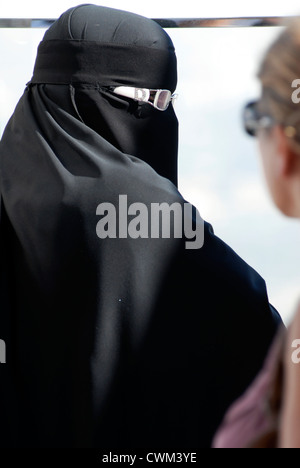 Islamic muslim woman wearing a burqa niqab burka and making a rude ...