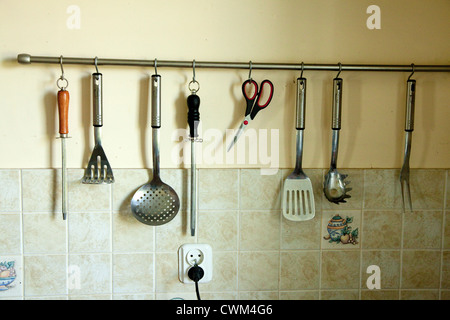 Kitchen tools hung up on wall ready for use in a Polish kitchen. Zawady Central Poland Stock Photo