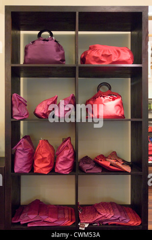 Vertical close up of lots of silk bags on sale inside a silk factory in Cambodia. Stock Photo