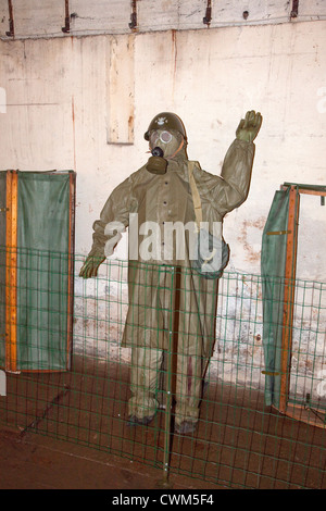 Mannequin displaying a German WWII poisonous gas protective outfit and mask in Hitler's Bunker. Konewka Central Poland Stock Photo