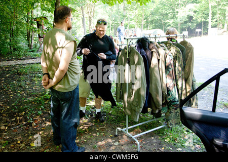 Army military camo camouflaged fatigues for sale at war surplus uniform shop outside Hitler's Bunker. Konewka Central Poland Stock Photo