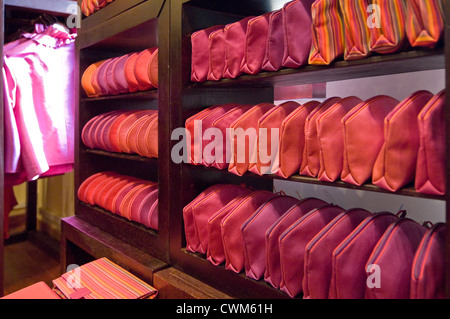 Horizontal close up of lots of silk bags and items of clothing on sale inside a silk factory in Cambodia. Stock Photo