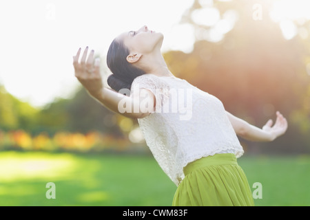 Young woman falling on meadow Stock Photo